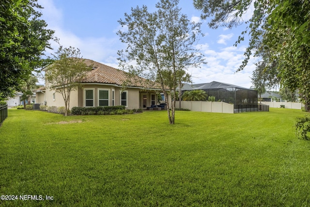 view of yard featuring a lanai and central AC unit