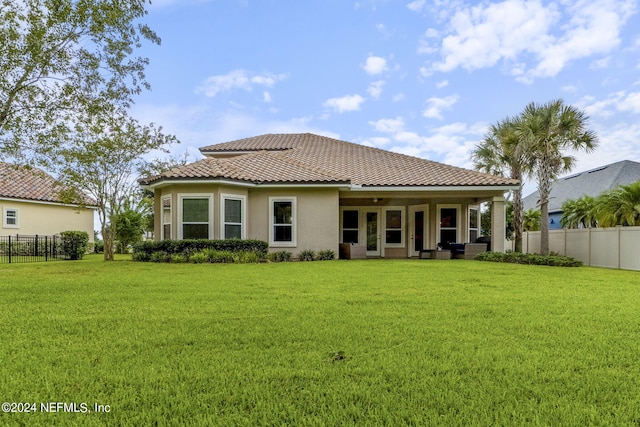 rear view of house with a yard