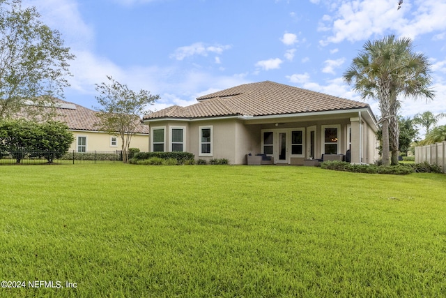 rear view of house featuring a lawn