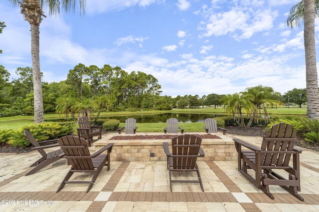 view of patio with a water view and an outdoor fire pit