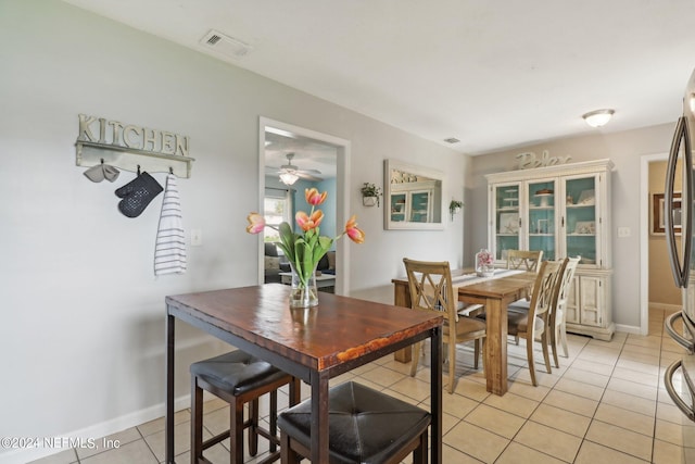 tiled dining area featuring ceiling fan