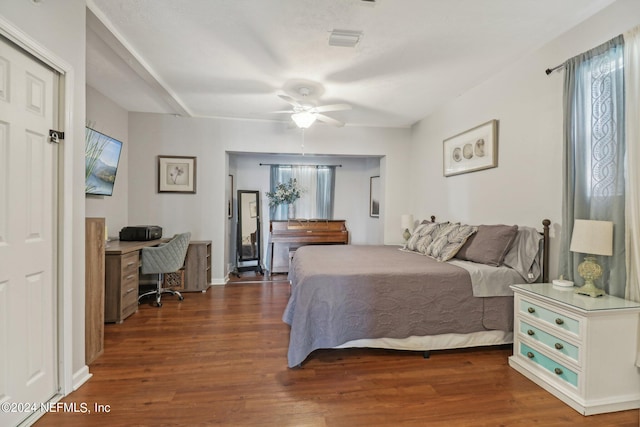 bedroom with ceiling fan and dark wood-type flooring