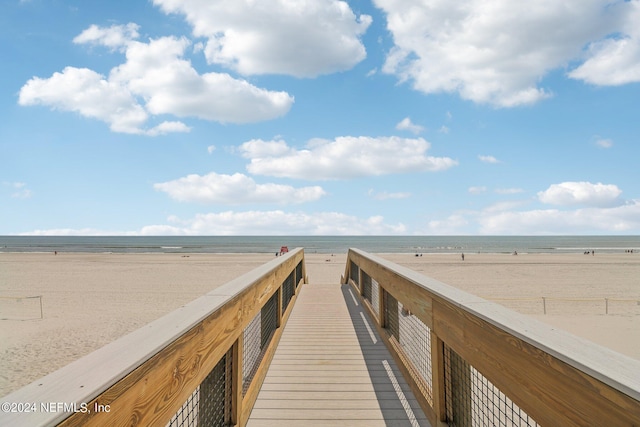 view of community with a water view and a view of the beach