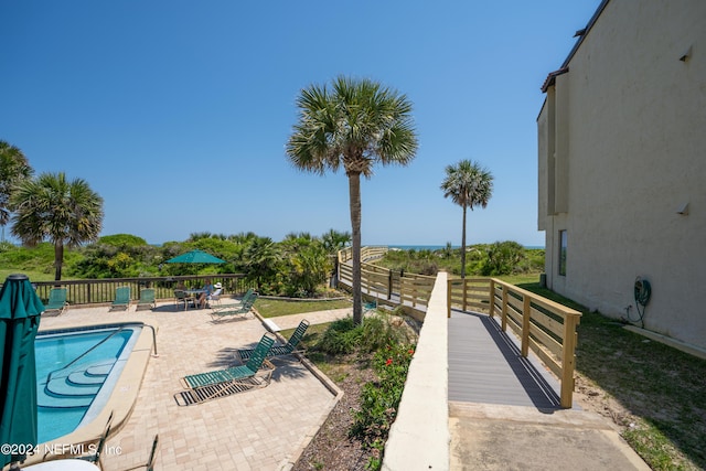 view of swimming pool with a patio area