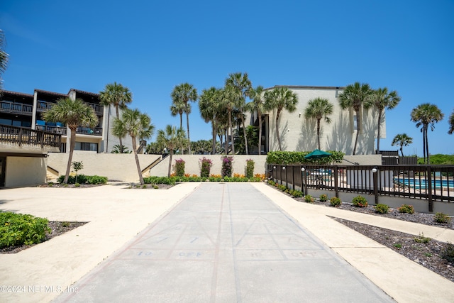 surrounding community with a pool and a patio