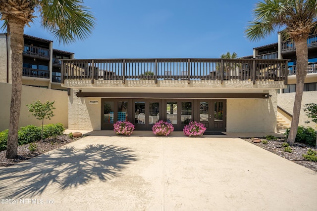 exterior space with french doors and a balcony