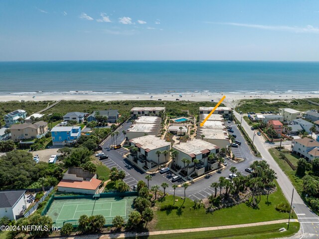 aerial view with a water view and a beach view