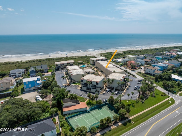 birds eye view of property with a view of the beach and a water view