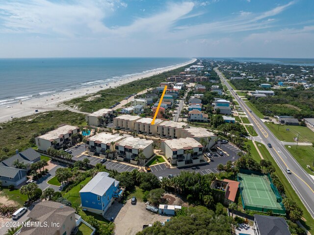 birds eye view of property featuring a water view and a beach view