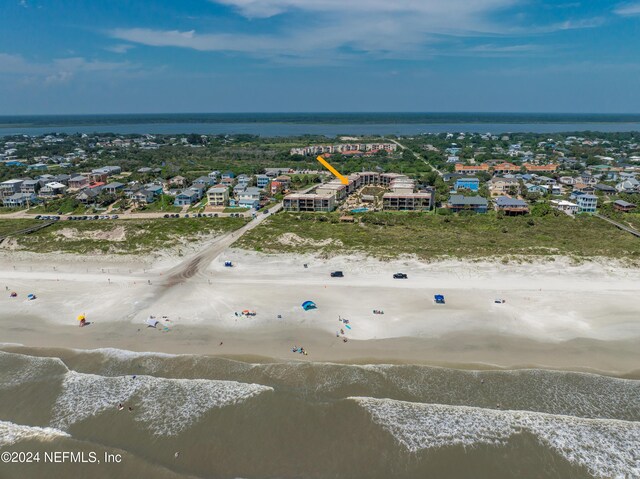 bird's eye view featuring a view of the beach and a water view