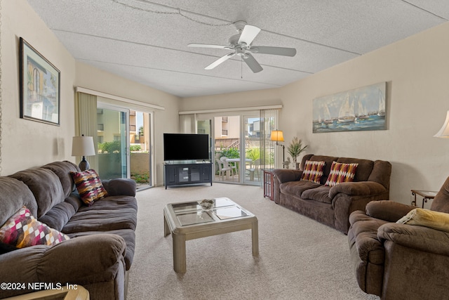 carpeted living room with ceiling fan, a healthy amount of sunlight, and a textured ceiling