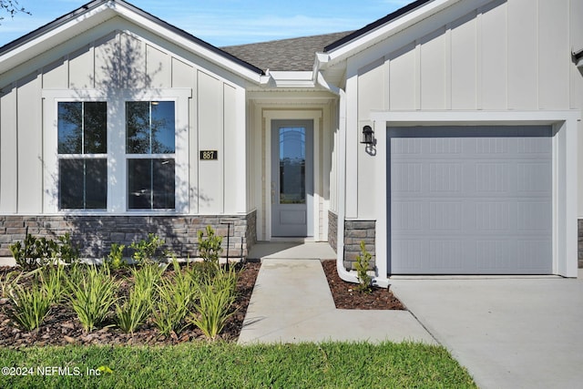 view of exterior entry featuring a garage