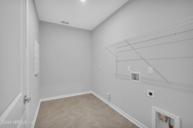 laundry area featuring washer hookup, hookup for a gas dryer, light tile patterned floors, and electric dryer hookup