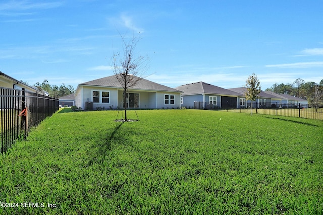 back of property with a lawn