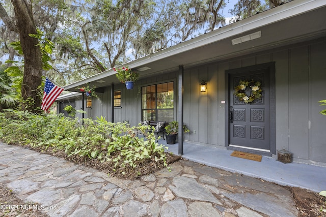 view of exterior entry with a porch