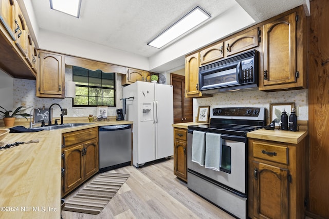 kitchen featuring sink, light hardwood / wood-style floors, and appliances with stainless steel finishes