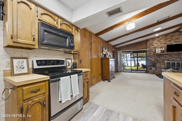 kitchen featuring vaulted ceiling with beams, stainless steel electric range oven, light hardwood / wood-style flooring, and a fireplace