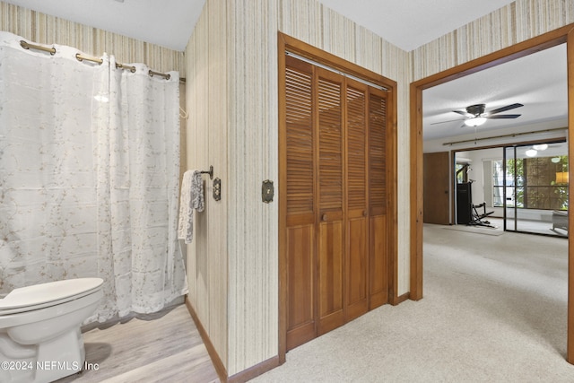 bathroom featuring ceiling fan and toilet