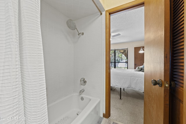 bathroom featuring a textured ceiling and shower / tub combo