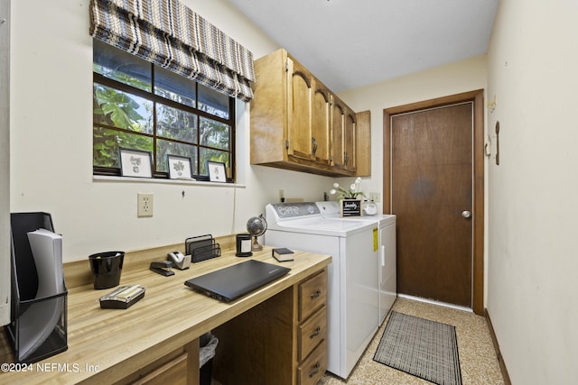 clothes washing area with washing machine and clothes dryer and cabinets