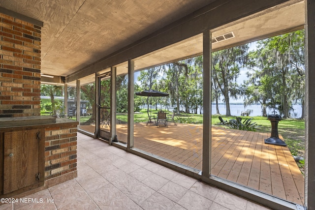 sunroom / solarium featuring a wealth of natural light and wood ceiling