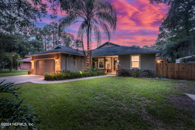 view of front of property featuring a yard and a garage