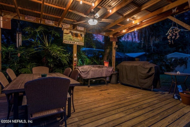 wooden terrace with a grill, ceiling fan, and a pergola