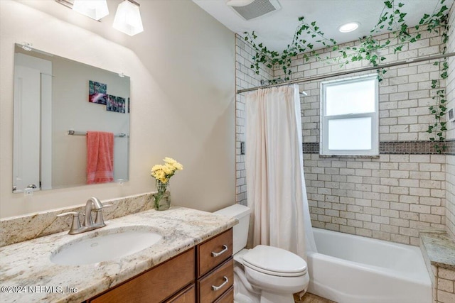 full bathroom featuring vanity, toilet, and shower / tub combo with curtain