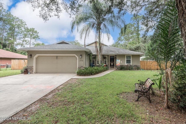 single story home featuring a garage and a front yard