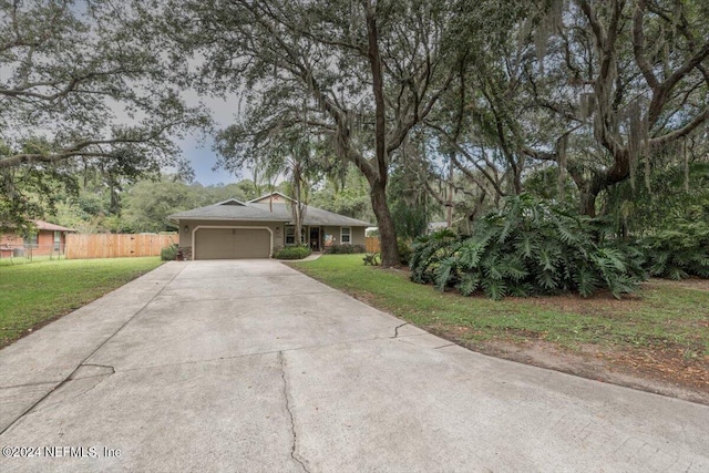 ranch-style house with a garage and a front lawn