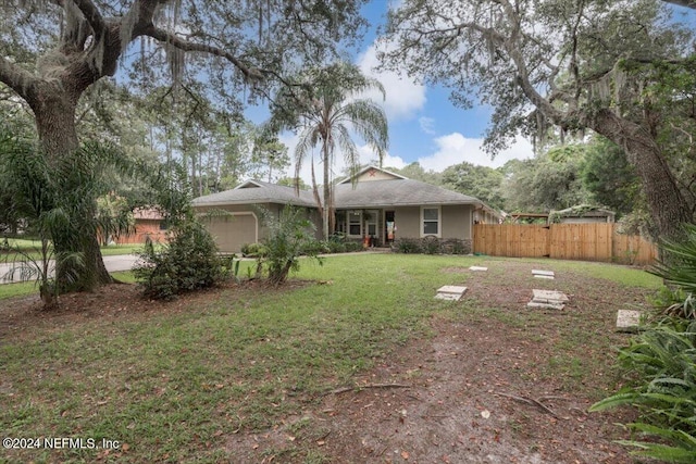 view of front of house with a garage and a front yard