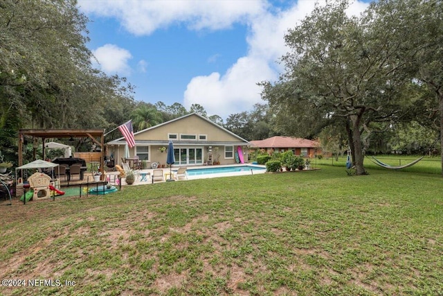 back of house featuring a gazebo, a patio area, and a lawn