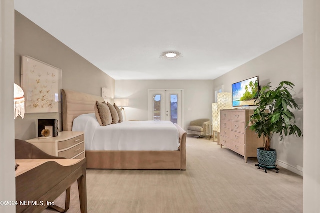 carpeted bedroom with french doors and access to exterior