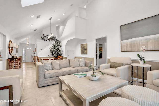 living area featuring high vaulted ceiling, recessed lighting, light tile patterned flooring, and visible vents