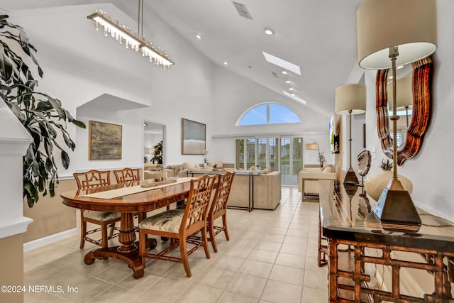 dining space with a skylight, visible vents, light tile patterned flooring, high vaulted ceiling, and recessed lighting