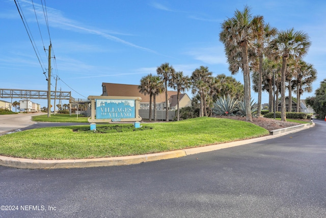 community sign featuring a lawn