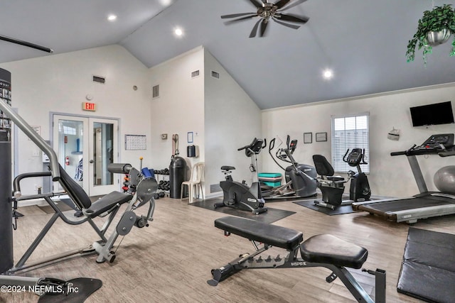 gym featuring hardwood / wood-style floors, high vaulted ceiling, french doors, and ceiling fan