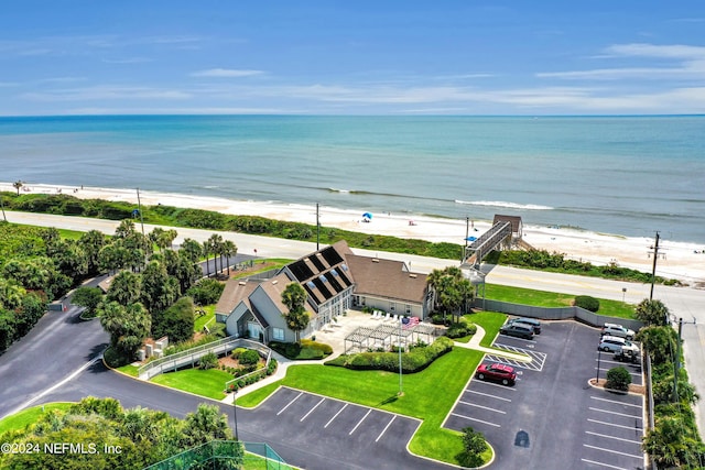 drone / aerial view featuring a water view and a view of the beach