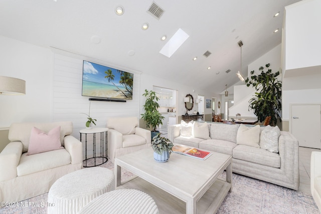 living area featuring high vaulted ceiling, a skylight, visible vents, and recessed lighting