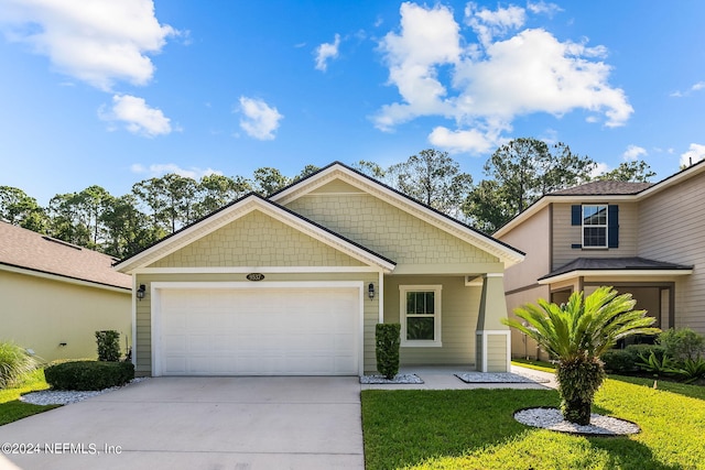 view of front of home featuring a garage and a front lawn