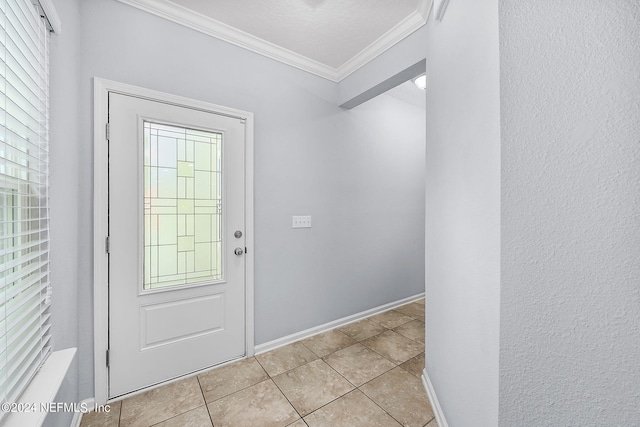 entryway with ornamental molding, a healthy amount of sunlight, and light tile patterned flooring