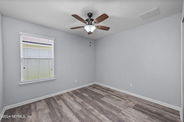 empty room featuring hardwood / wood-style flooring, ceiling fan, and a textured ceiling