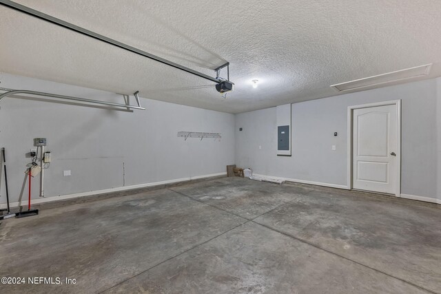 garage featuring a garage door opener and electric panel