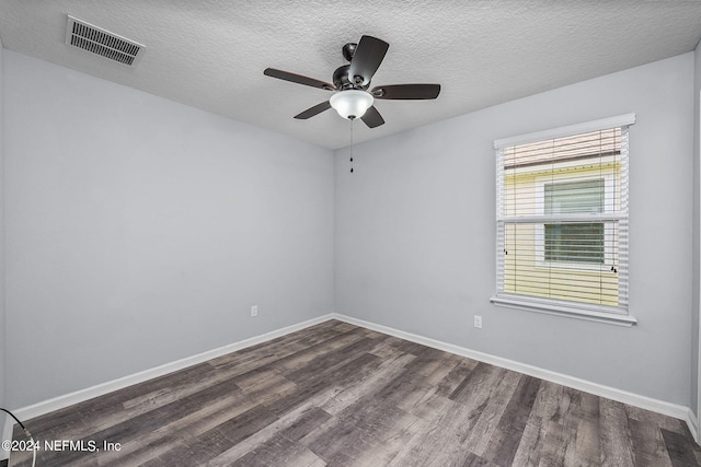 empty room featuring ceiling fan, dark hardwood / wood-style floors, and a textured ceiling