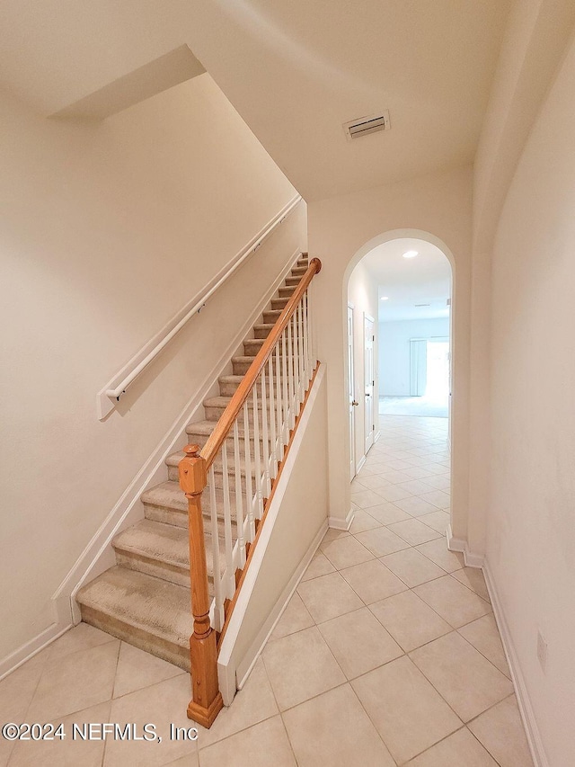 stairway featuring tile patterned floors