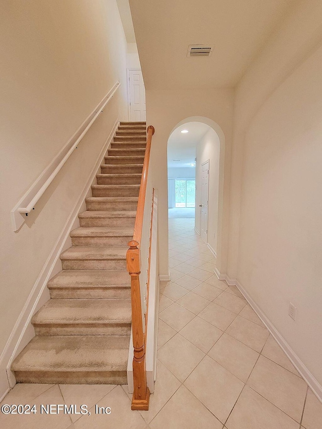 staircase featuring tile patterned floors