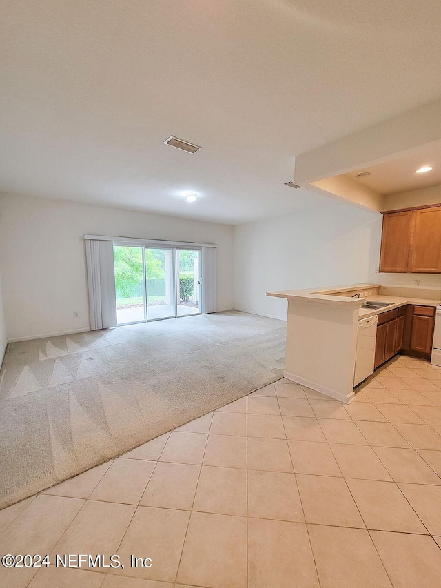 kitchen with light colored carpet, kitchen peninsula, dishwasher, and range