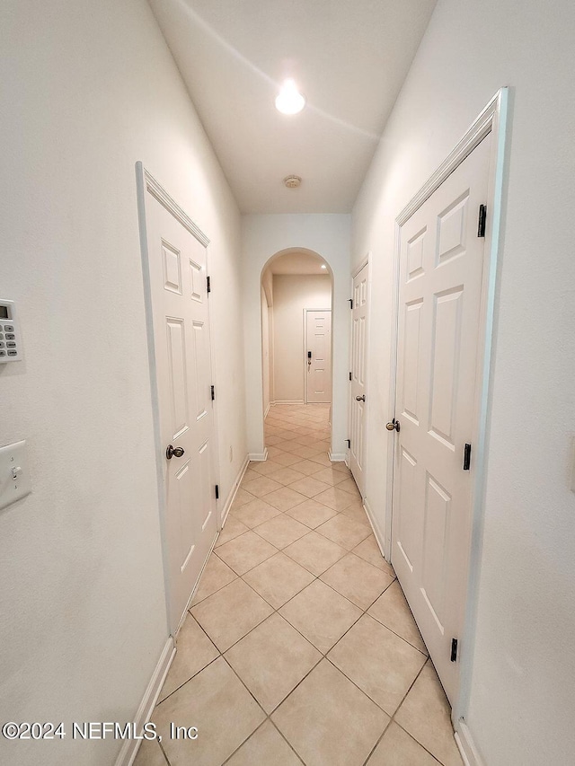 corridor with light tile patterned floors