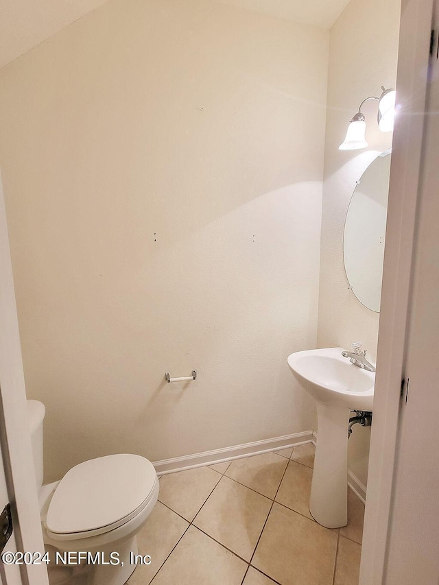 bathroom featuring tile patterned flooring and toilet