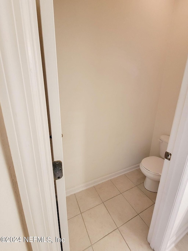 bathroom featuring tile patterned flooring and toilet